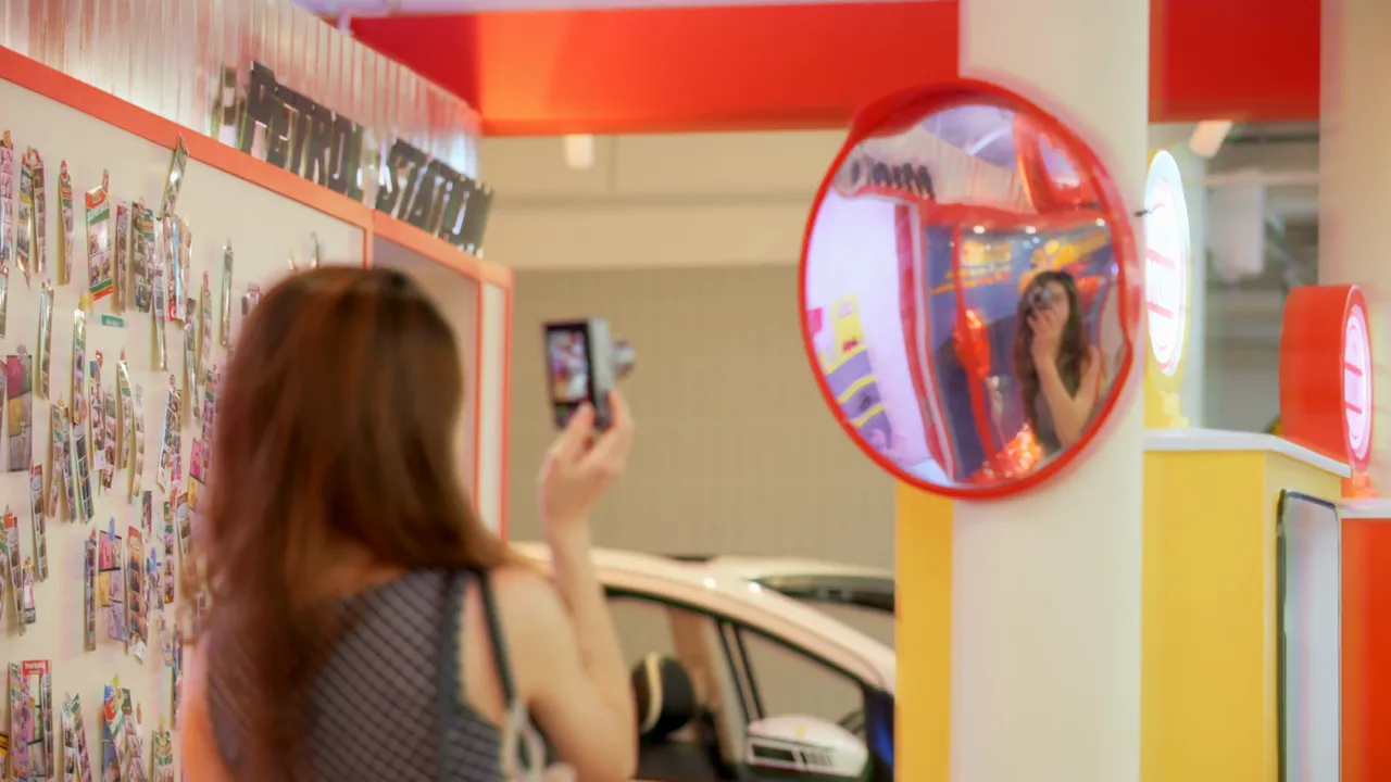 A visitor taking a photo inside the space, from the launch film